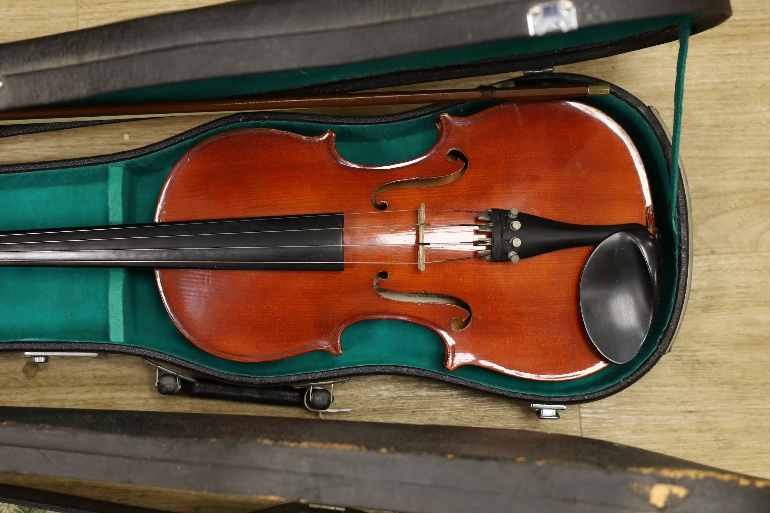 Two cased violins, one bow